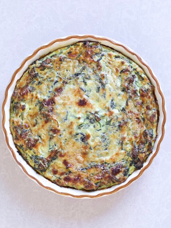 Italian frittata with spinach, onion, and ricotta in a baking dish.