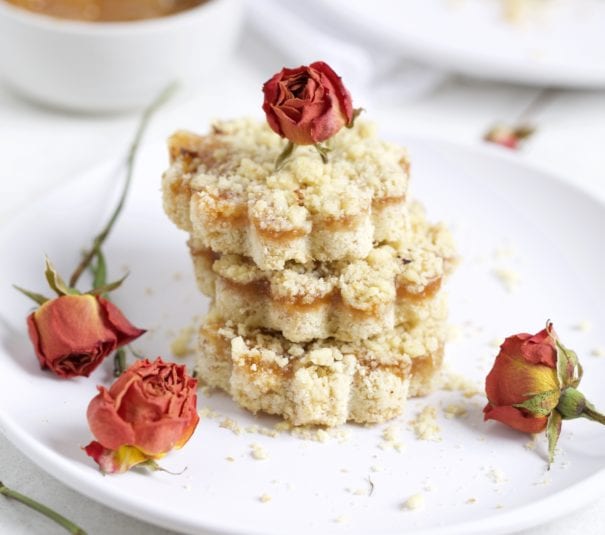 Italian Crumb cake with jam on a plate with dried roses