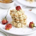Italian Crumb cake with jam on a plate with dried roses
