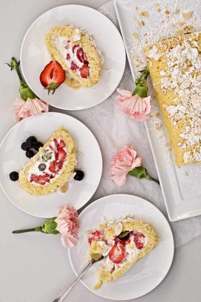 Vanilla Cake Roll with Berries slices on a several plates