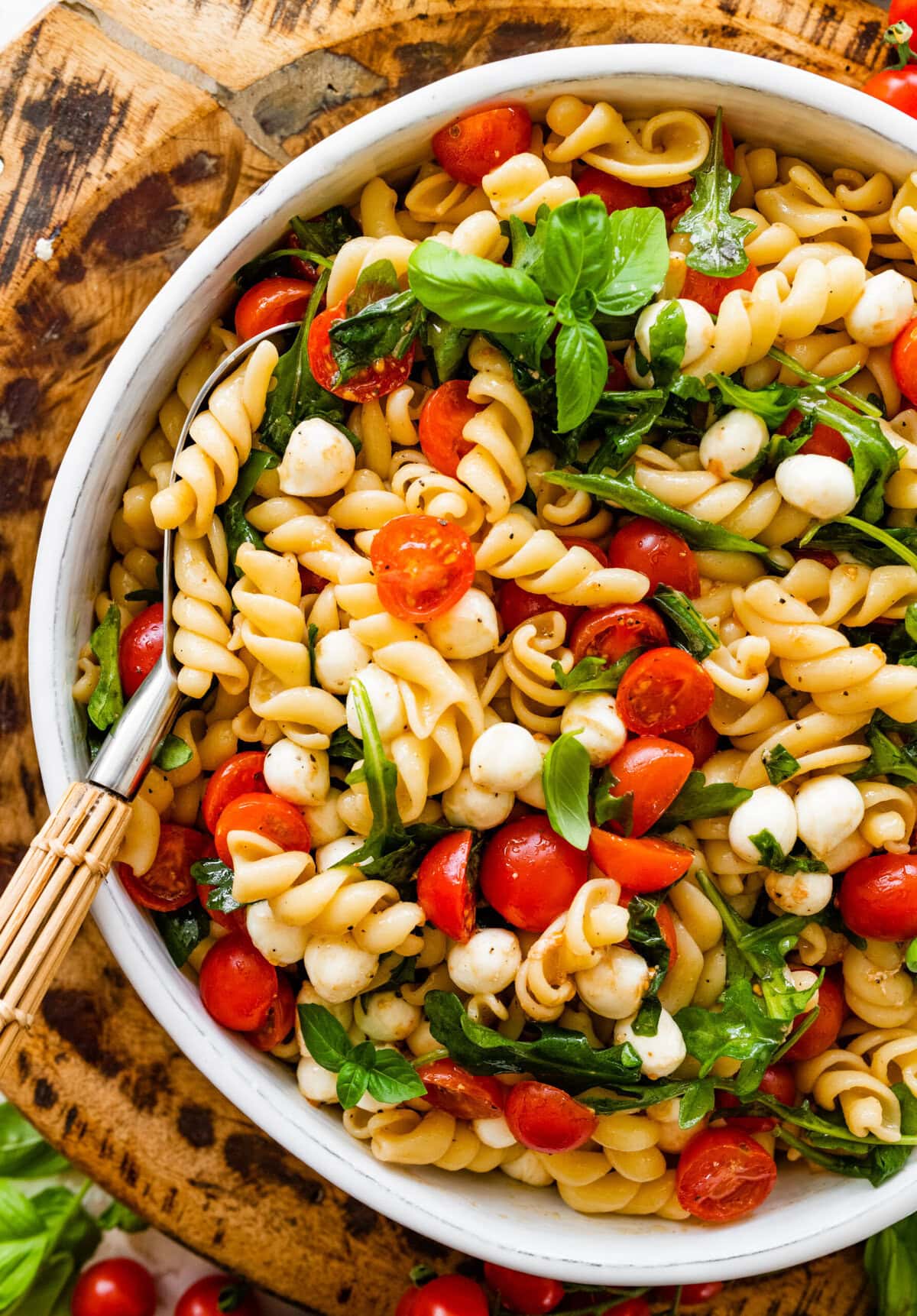 Caprese pasta salad with tomatoes, basil and mozzarella.