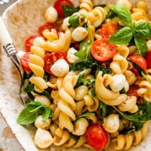 Caprese pasta salad with tomatoes, mozzarella and basil