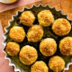 twice baked zucchini in a baking pan on a wooden board.