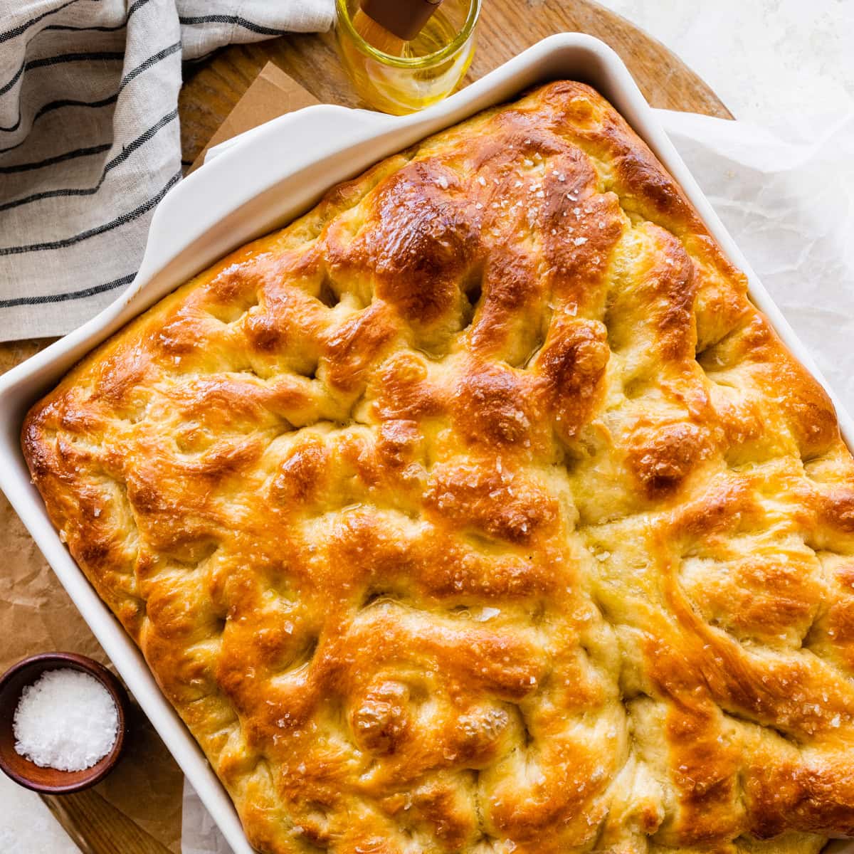 no-knead focaccia in a pan after it is done baking.