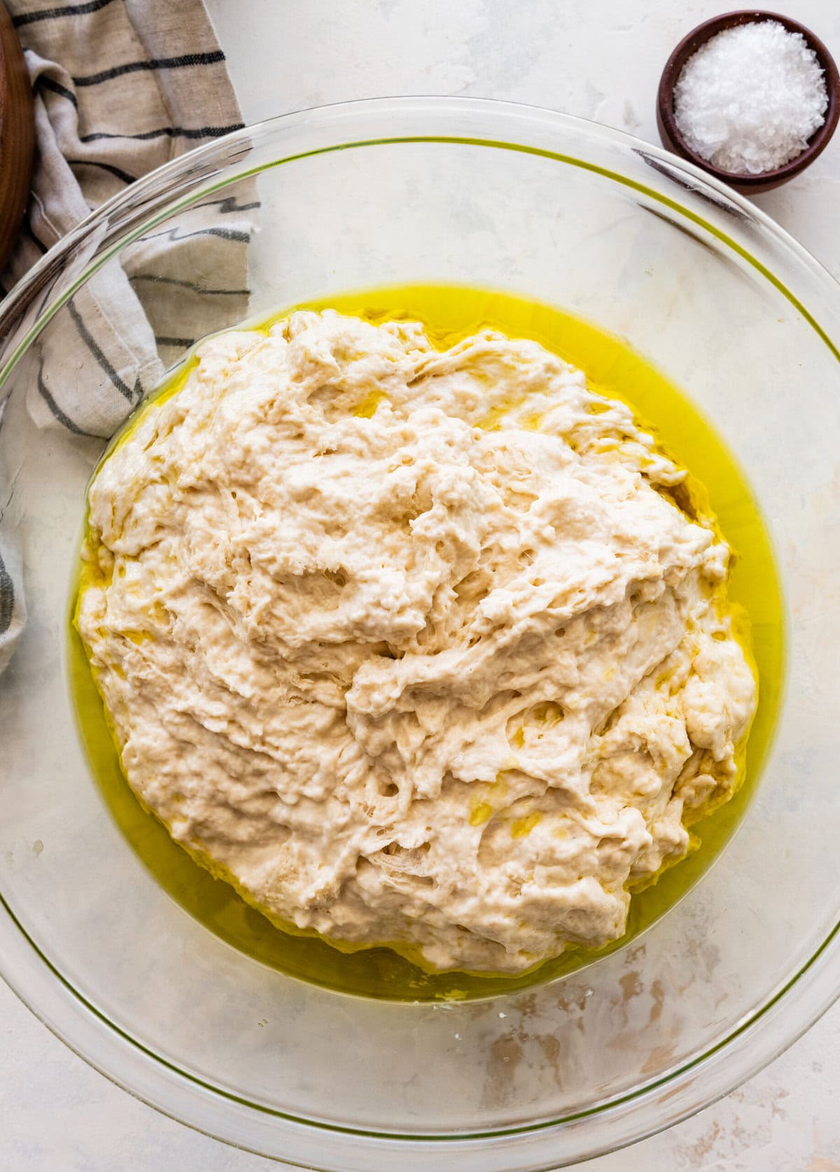 how to make no-knead focaccia bread step-by-step: add the dough to a clean oiled bowl.