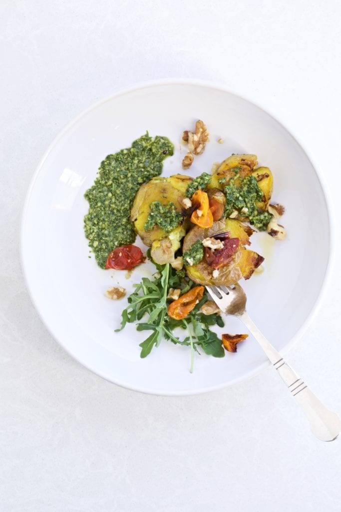 Pesto Smashed Potatoes and Roasted Tomatoes on a plate