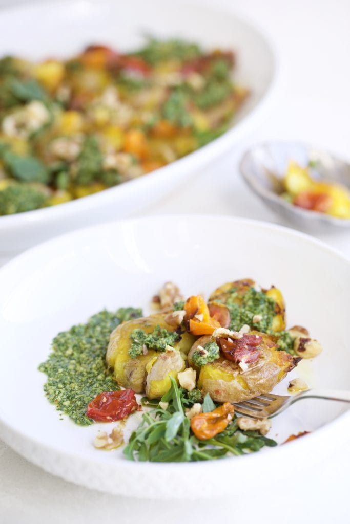 Pesto Smashed Potatoes and Roasted Tomatoes on a plate