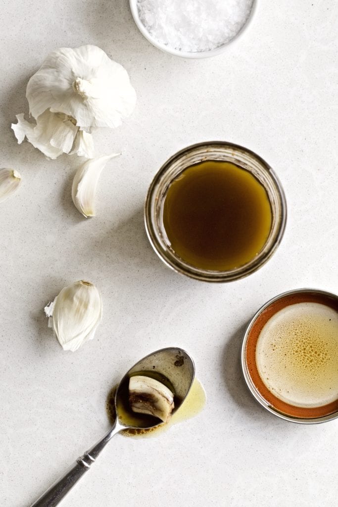 Spoon next to an open jar of Italian balsamic vinaigrette.