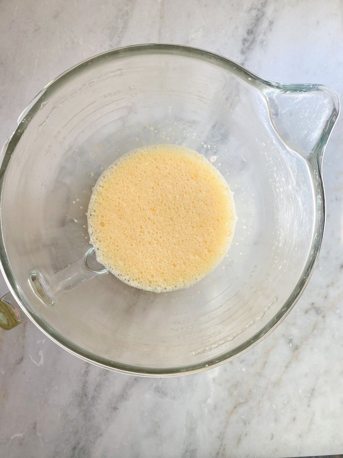 process for making frozen lemon bars- mixing egg yolks and lemon juice and zest.