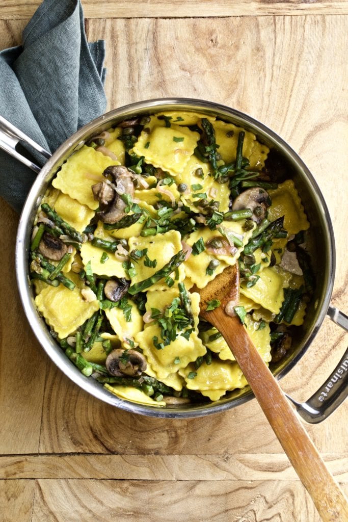 Ravioli mushrooms and asparagus in a skillet pan