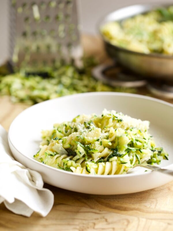 Zucchini pasta on a plate with a fork.