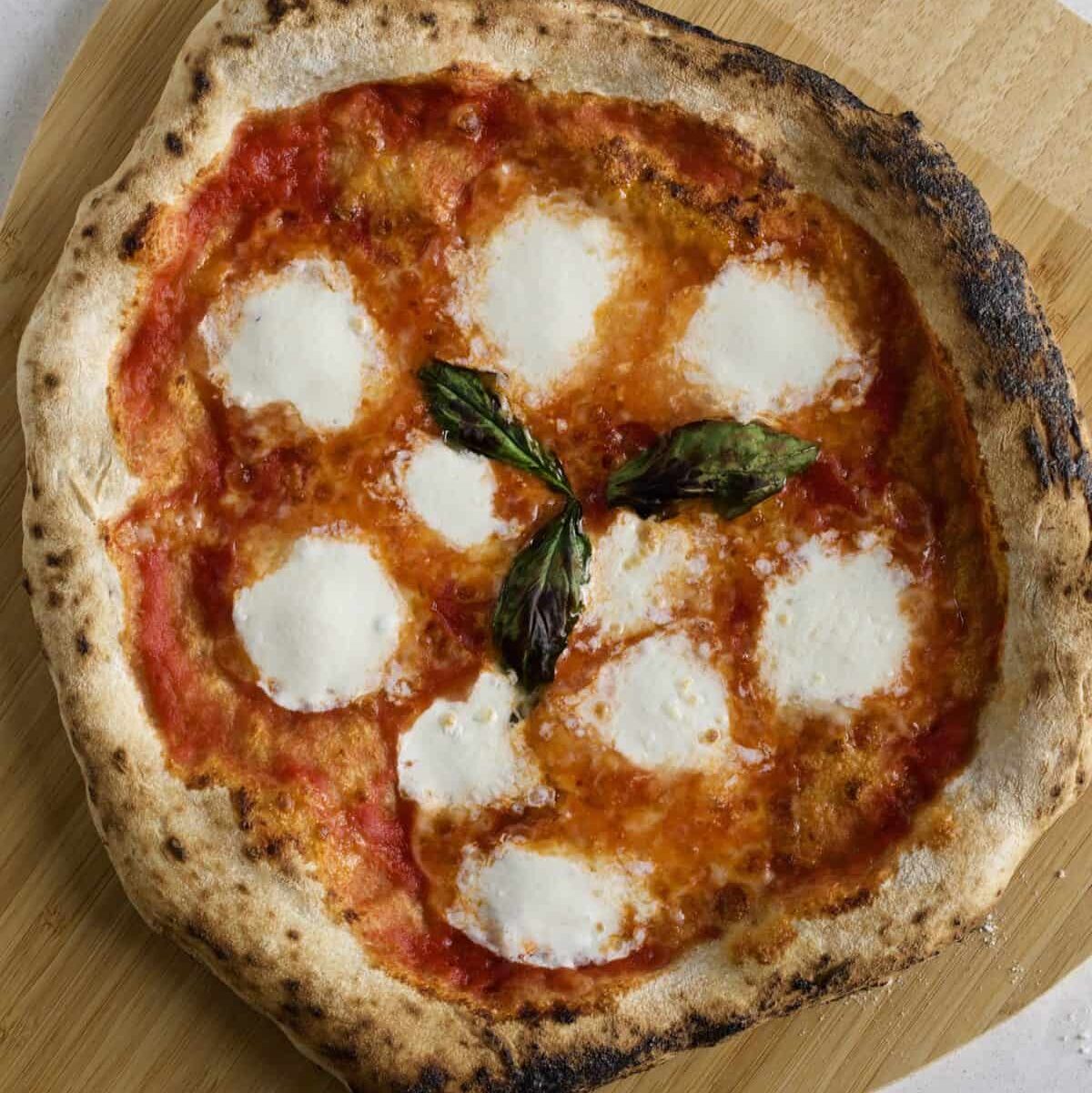 pizza napoletana (Neapolitan) on a wood board