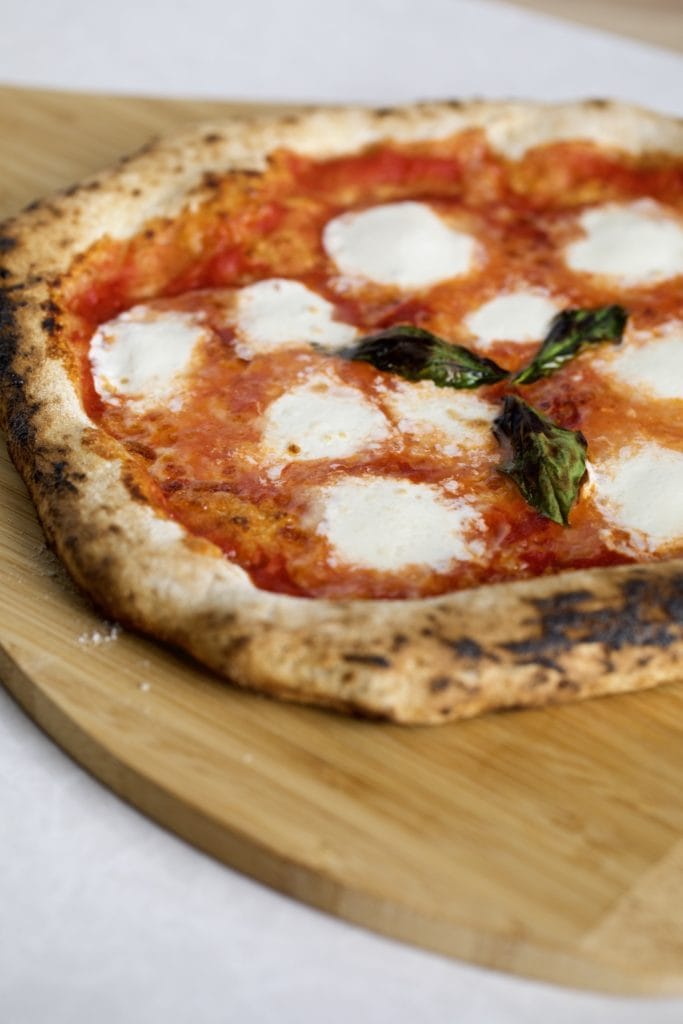 Neapolitan pizza on a wooden board.