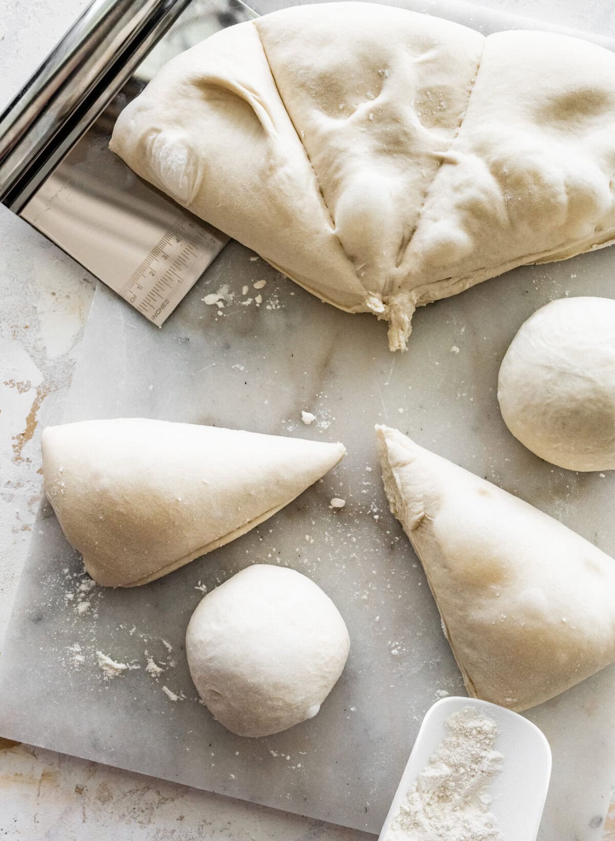 marble surface with dough balls.