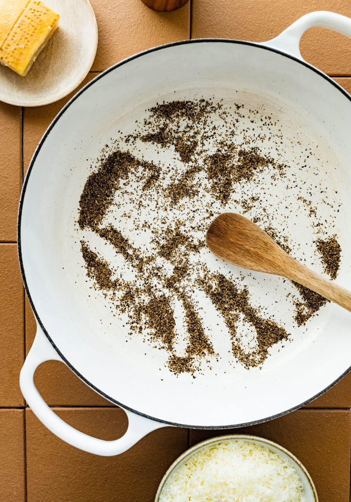 toasting the pepper in the pan.
