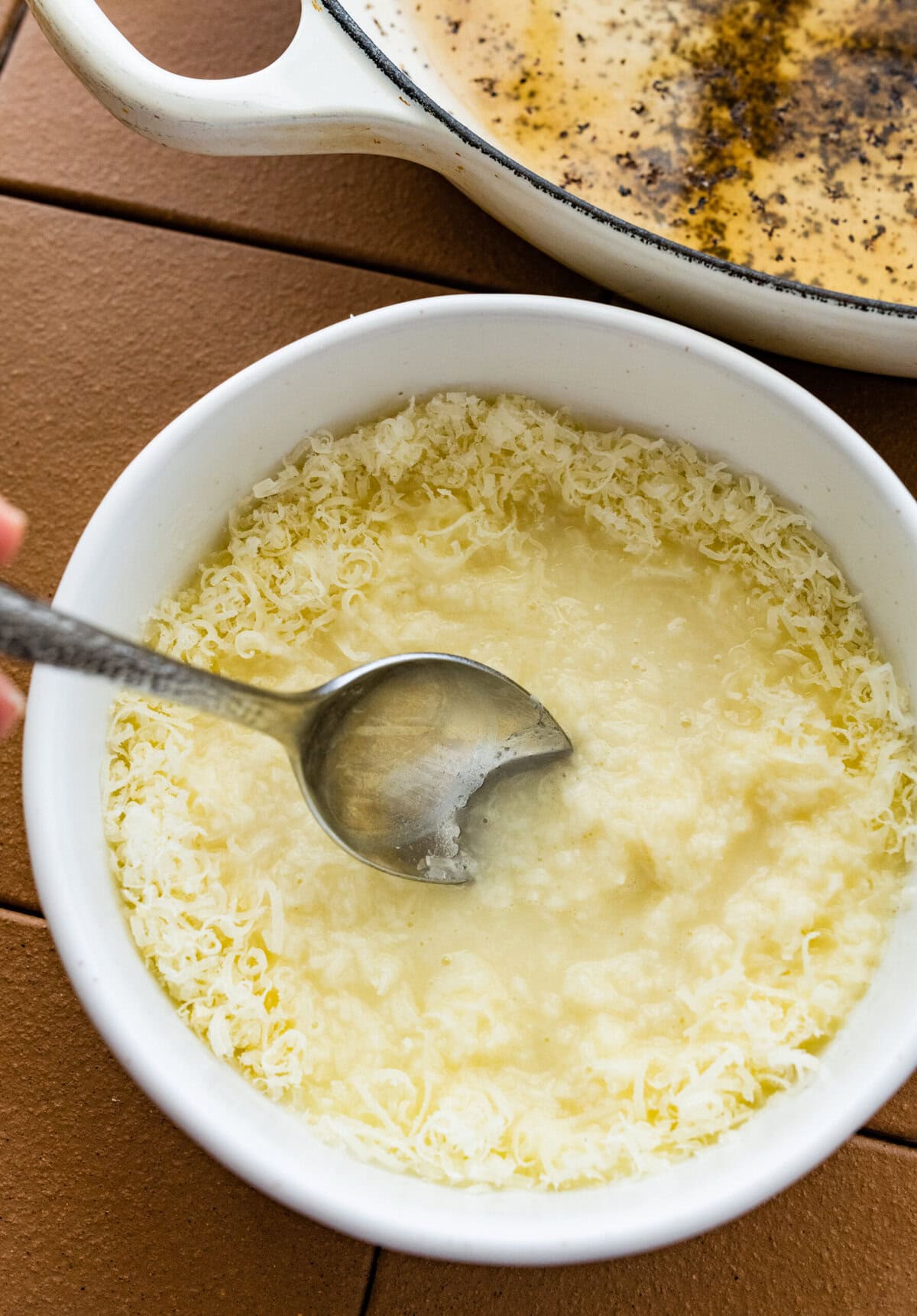 making a paste with the parmigiano and hot water.