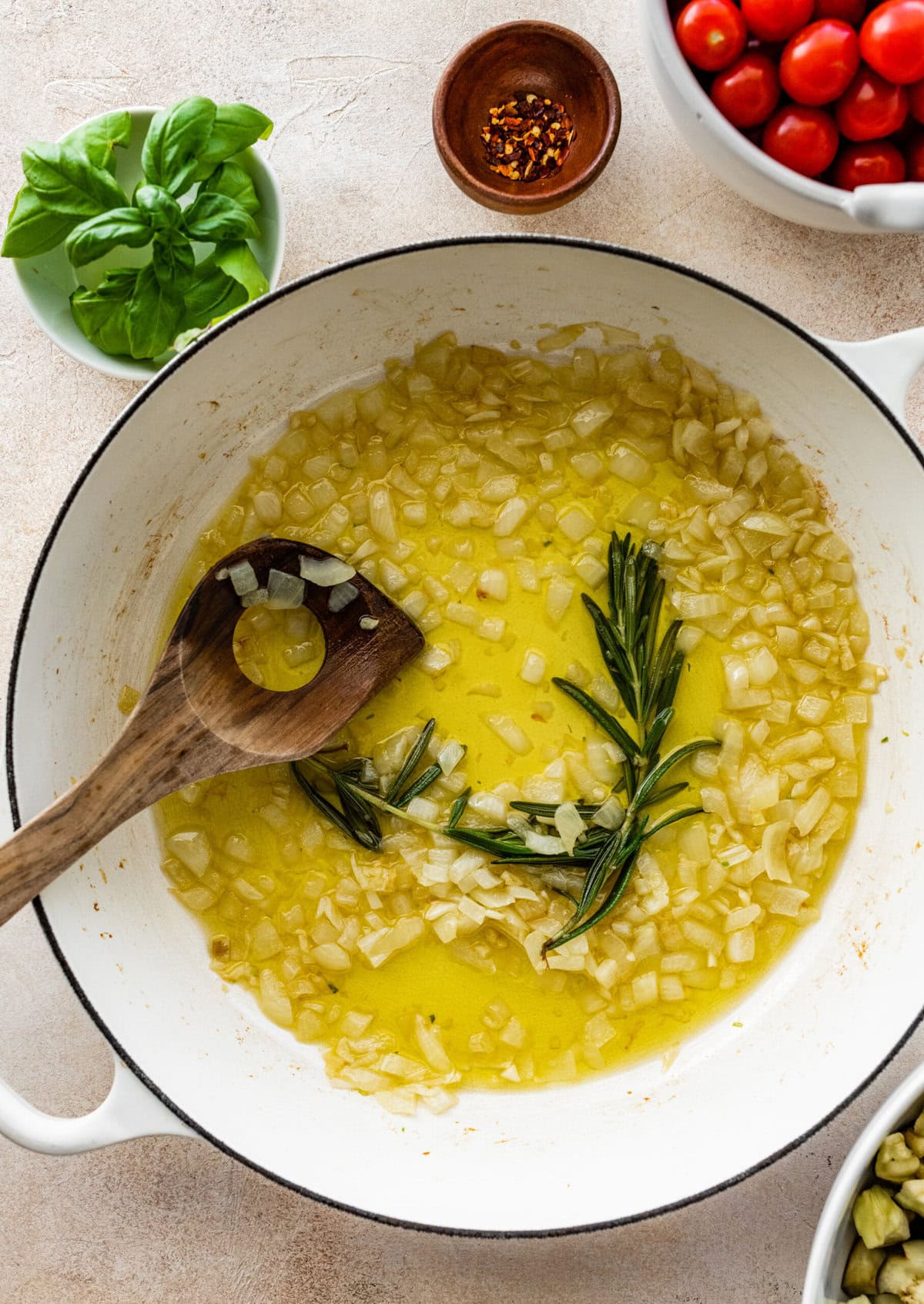 olive oil, onion, and rosemary in a pan.