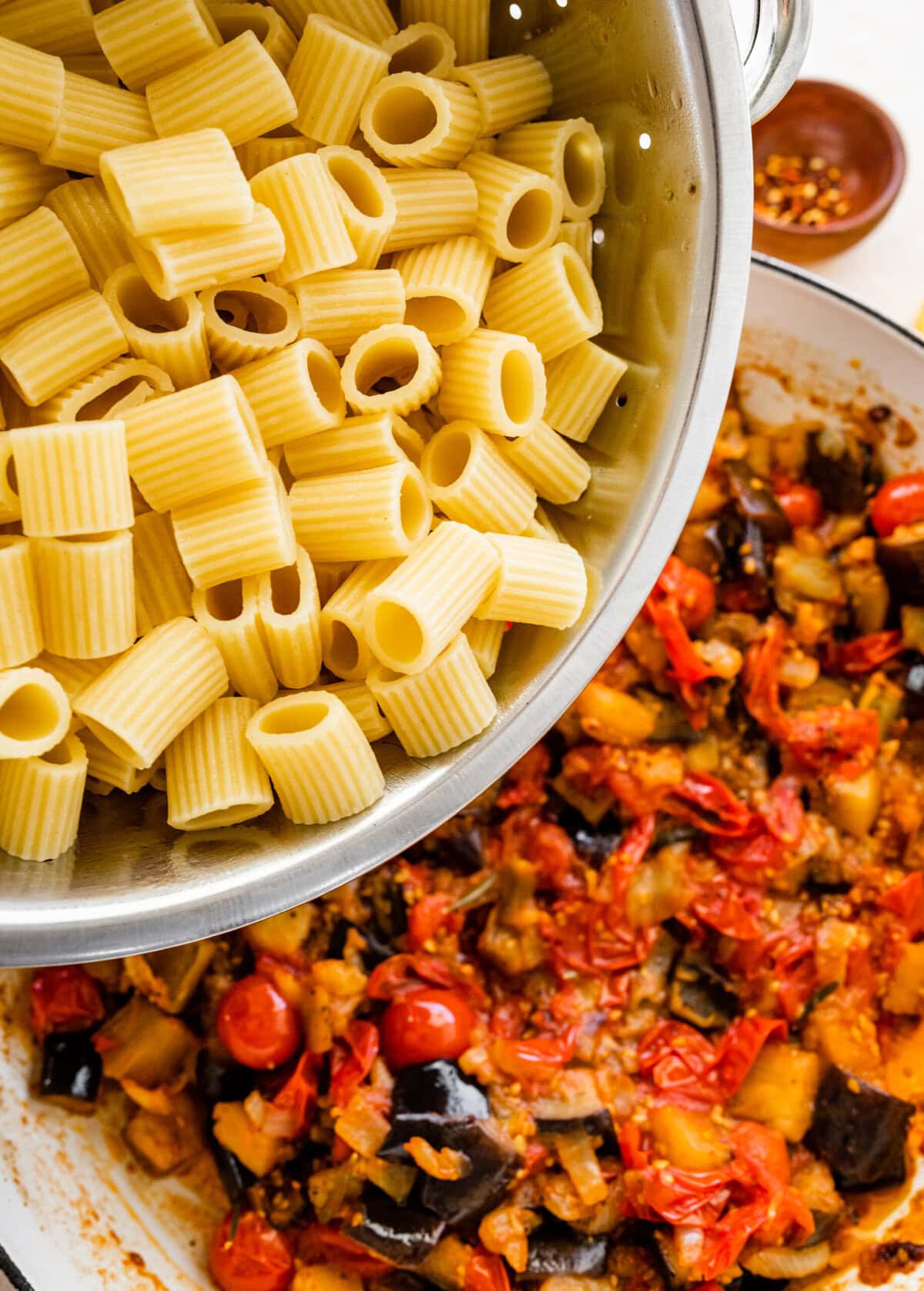 add al dente pasta to the pan with eggplant and tomatoes.
