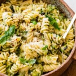 Pasta with zucchini and cheese in a bowl with a fork in it.