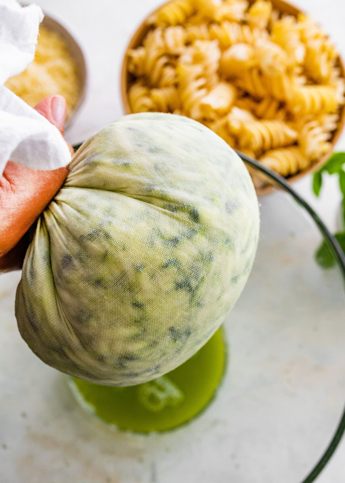 A person is holding a green vegetable in their hand.