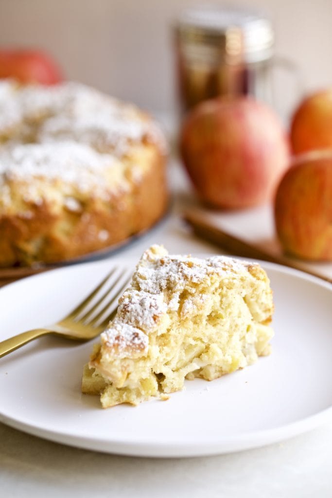 Slice of Italian apple cake on a plate with a fork.