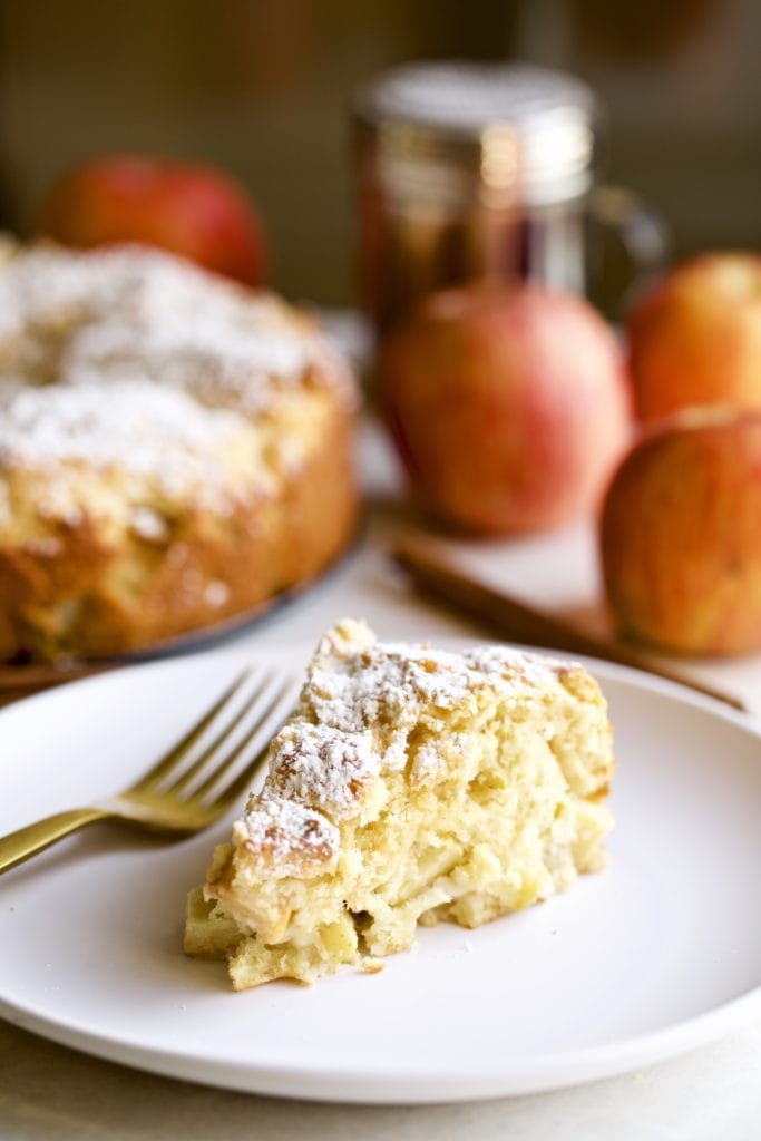 Slice of Italian apple cake on a plate with a fork.
