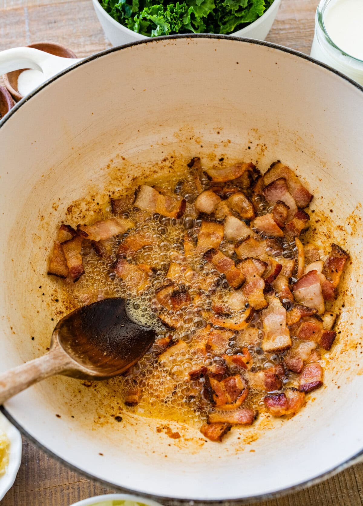 Bacon cooking in a large pot.