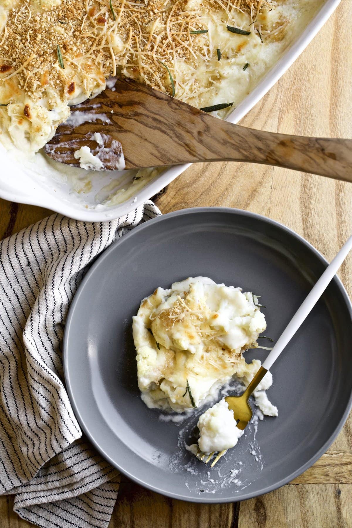 creamy cauliflower bake white sauce on a spoon