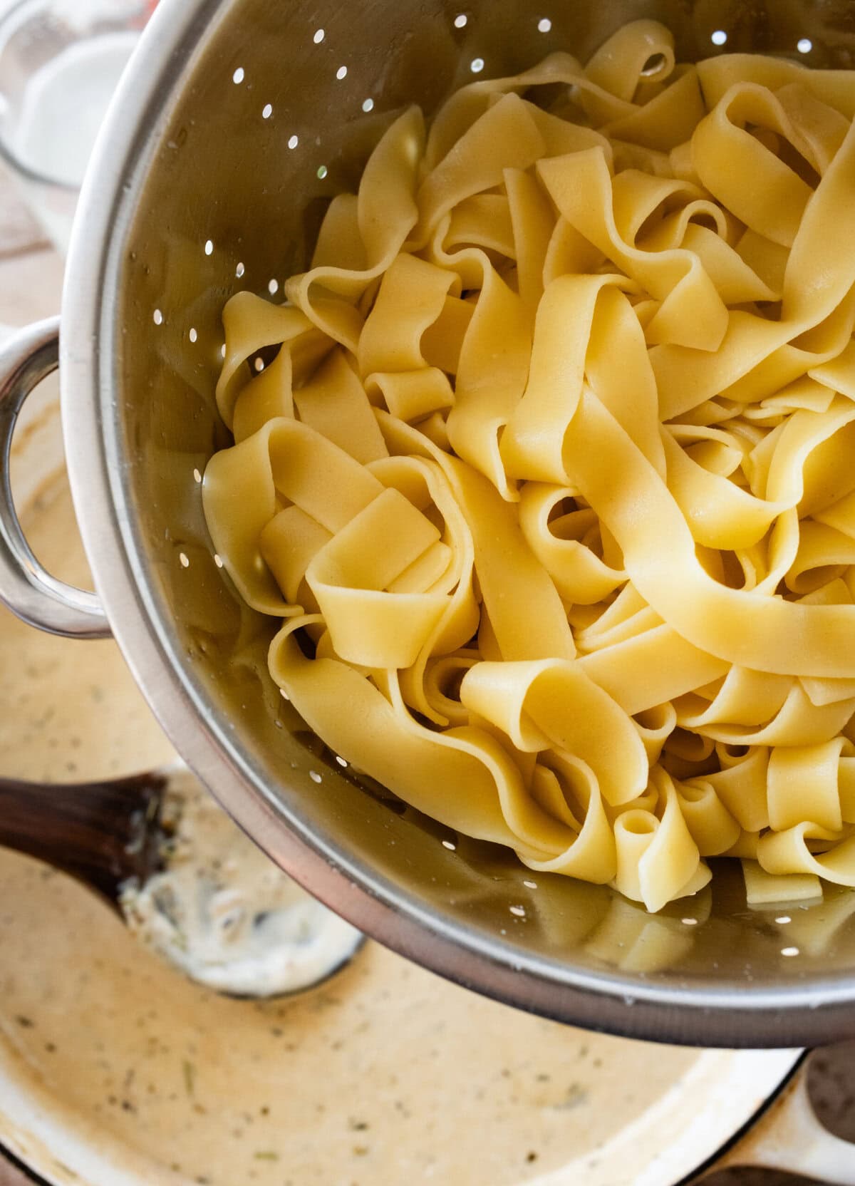 cooked pappardelle in a strainer.