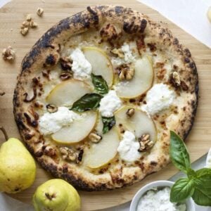 gorgonzola pizza with extra toppings nearby.