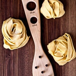 Process of making a homemade pappardelle pasta recipe with a pasta spoon and nests of pasta.