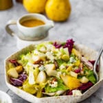 pear gorgonzola salad in a salad bowl with a fork in it ready to eat.