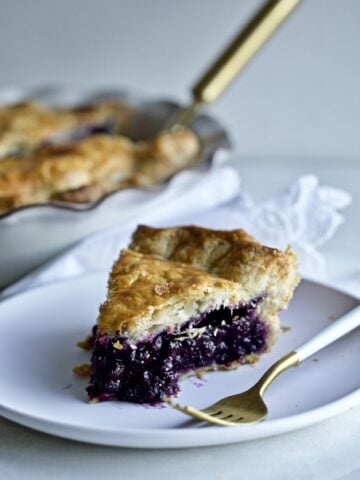Best Bursting Blueberry Pie Frozen Berries slice on a plate