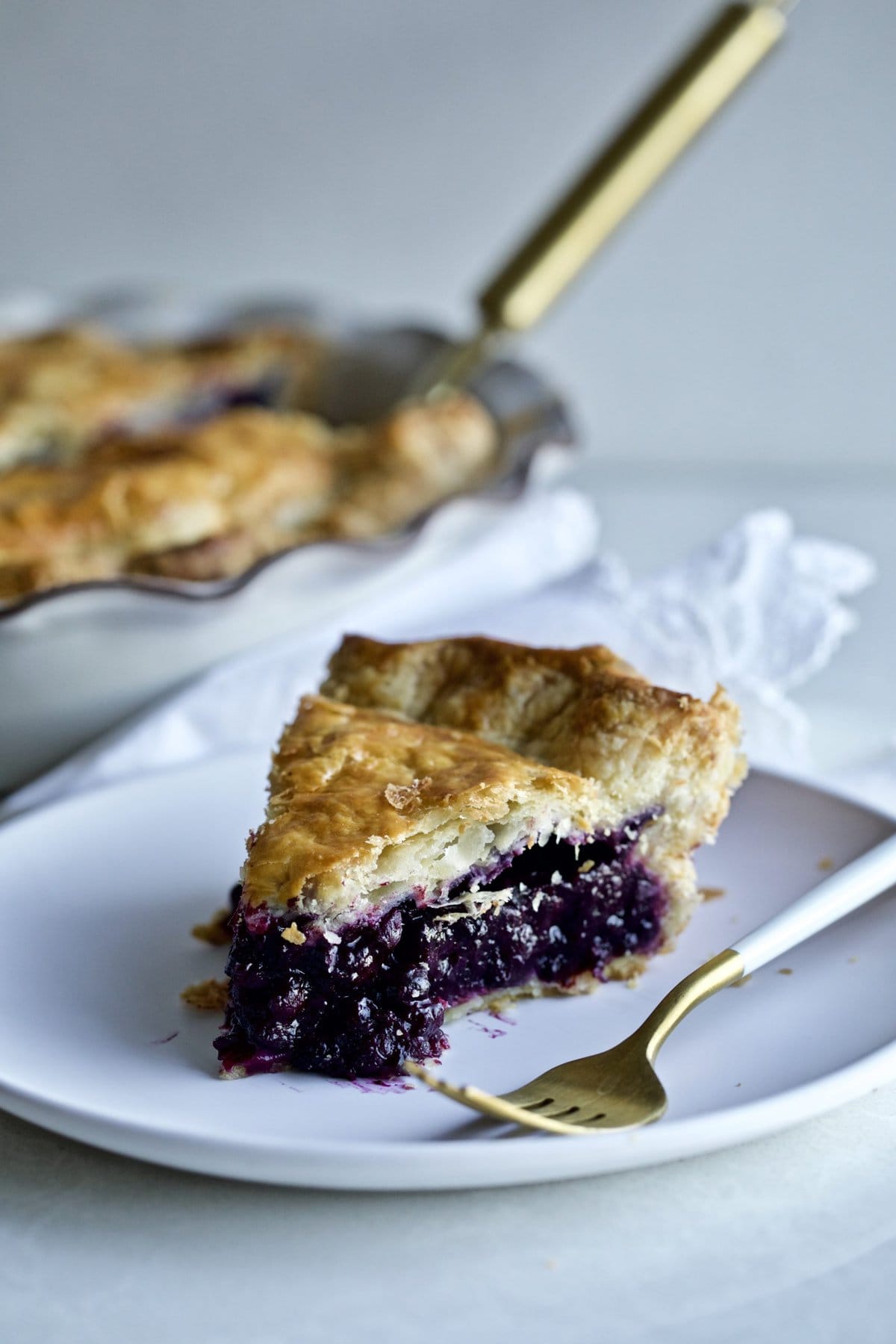 Best Bursting Blueberry Pie Frozen Berries slice on a plate