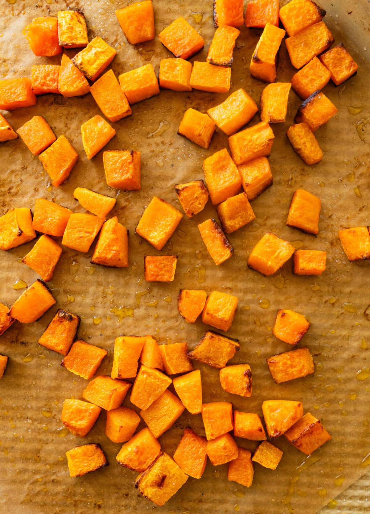Baked butternut squash on a baking sheet.