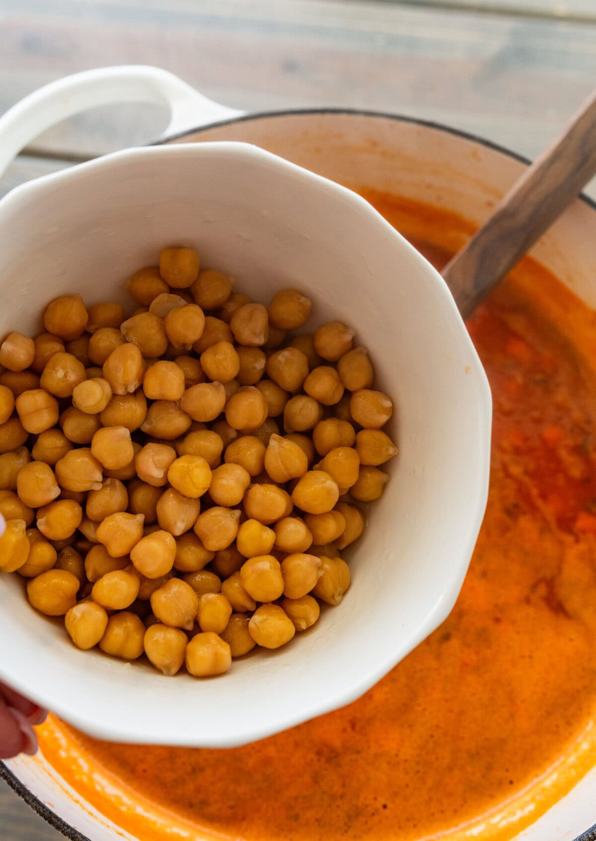 A bowl of whole chickpeas over the pot of soup.