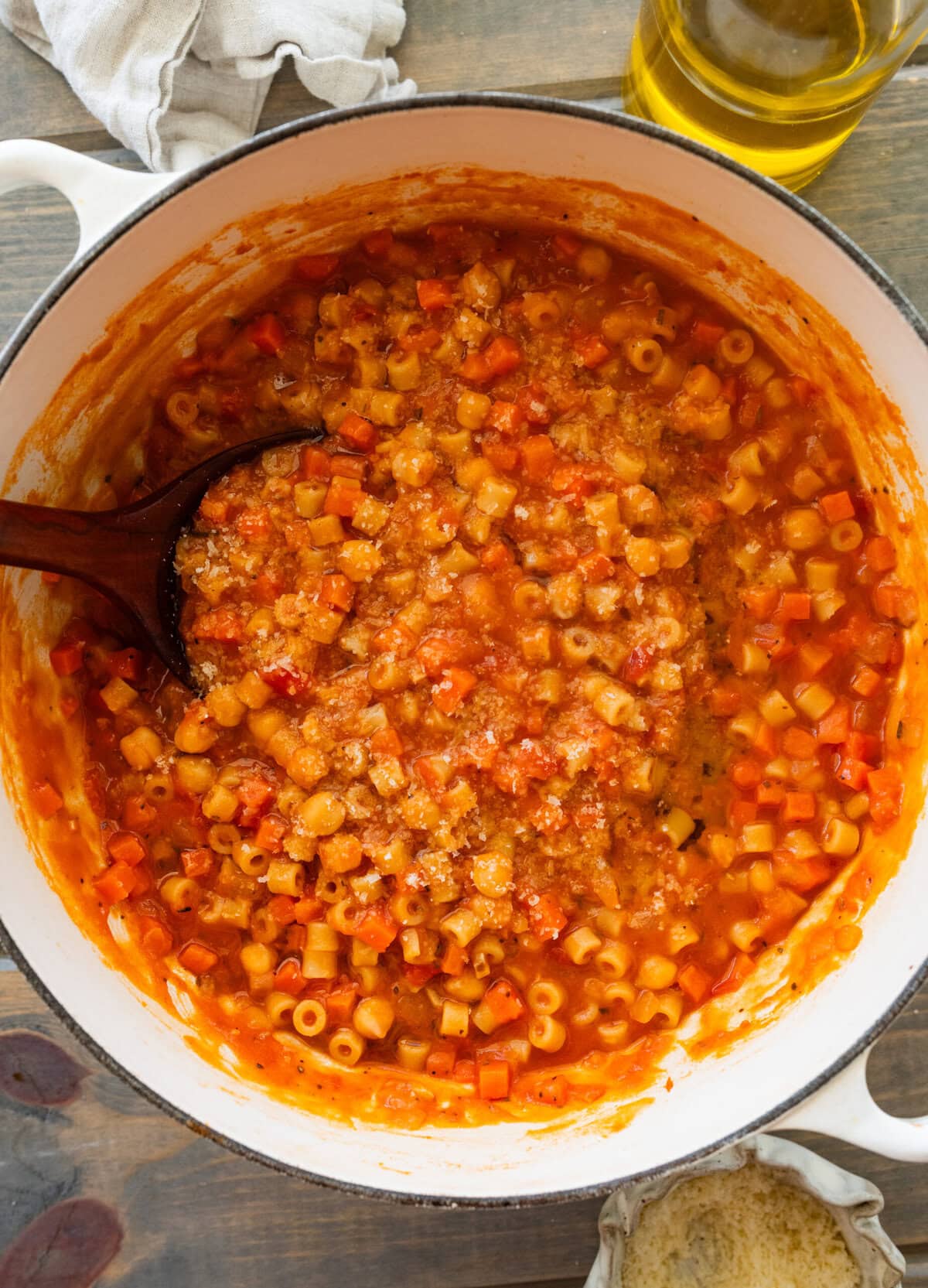 A pot of pasta e ceci with a ladle resting inside.