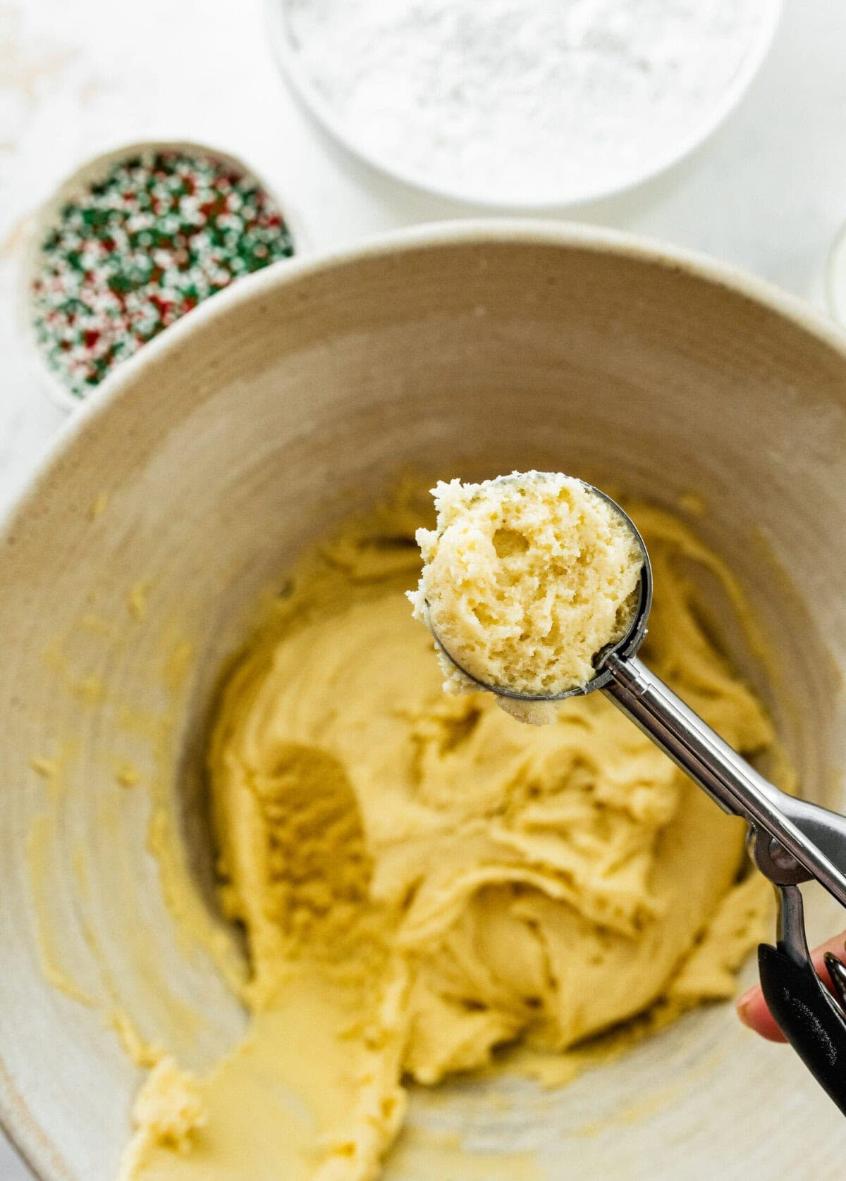 Scooping the anginetti cookie dough.