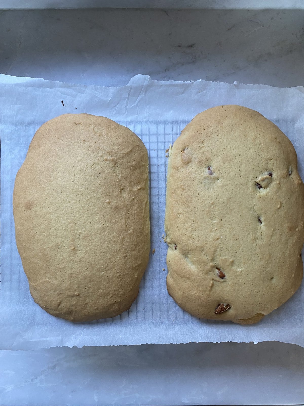 Two biscotti loaves on a lined wire rack.
