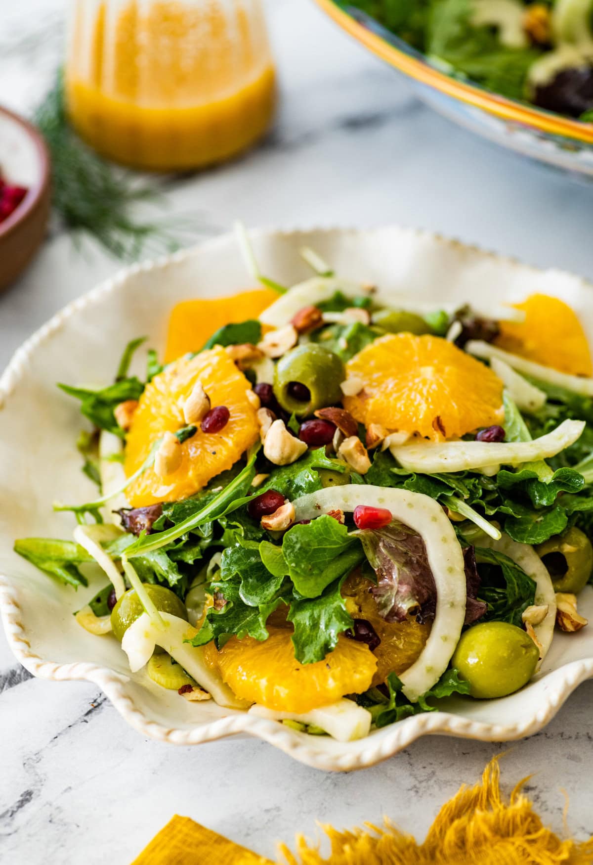 Italian orange and fennel salad on a plate. Orange slices cut in rounds and fennel visible on top.