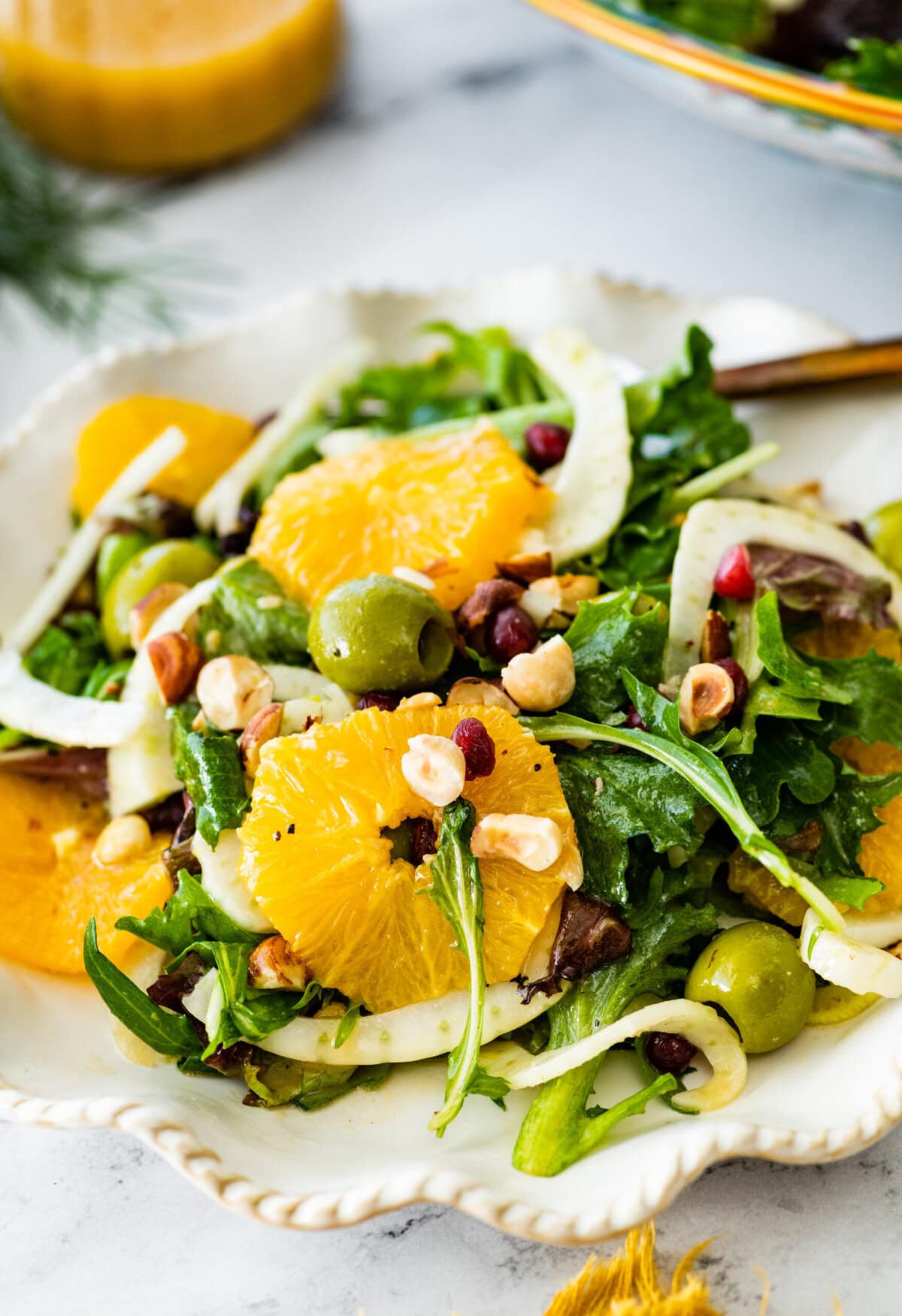 Italian orange and fennel salad on a plate. Orange slices cut in rounds and fennel visible on top.