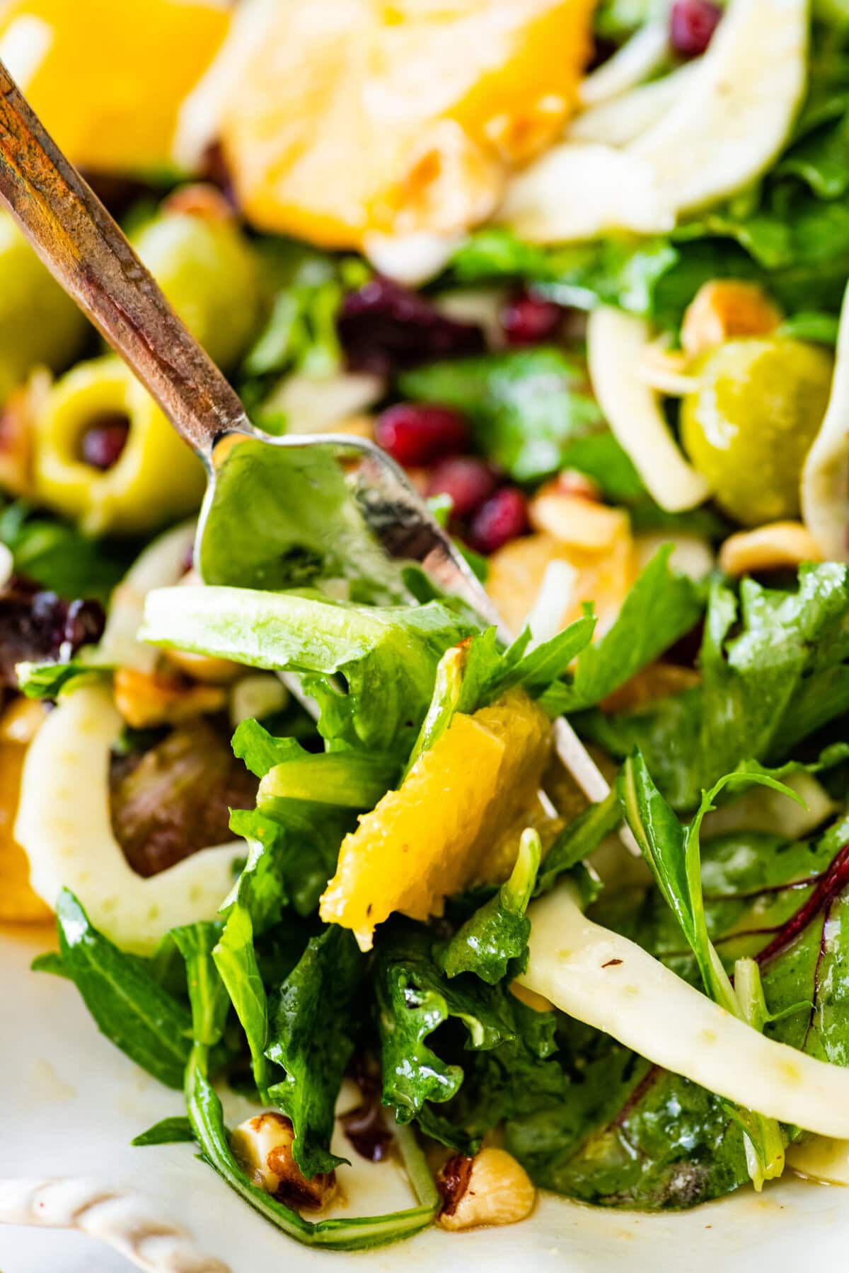 Italian orange and fennel salad on a plate. Orange slices cut in rounds and fennel visible on top.
