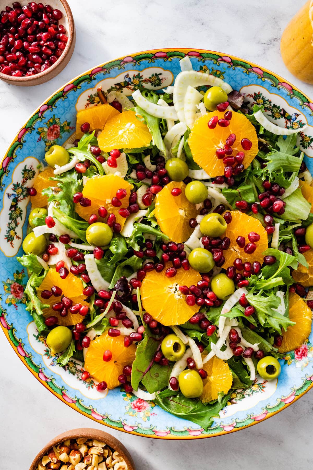 add the pomegranate seeds and olives to the salad bowl with the rest of the ingredients.