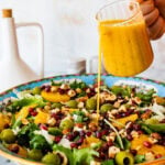 pour the orange salad dressing vinaigrette in the salad in the serving bowl.
