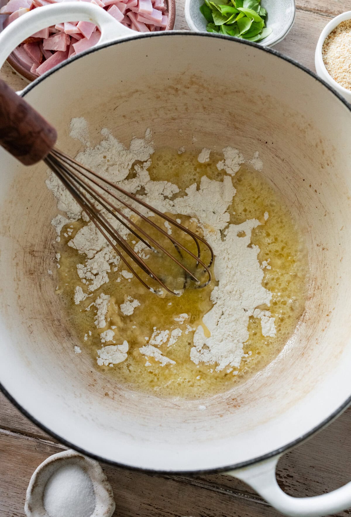 Whisking the flour into the pot.