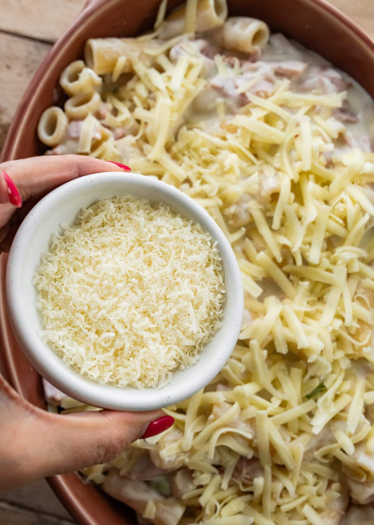 Parmesan being added to the pot.