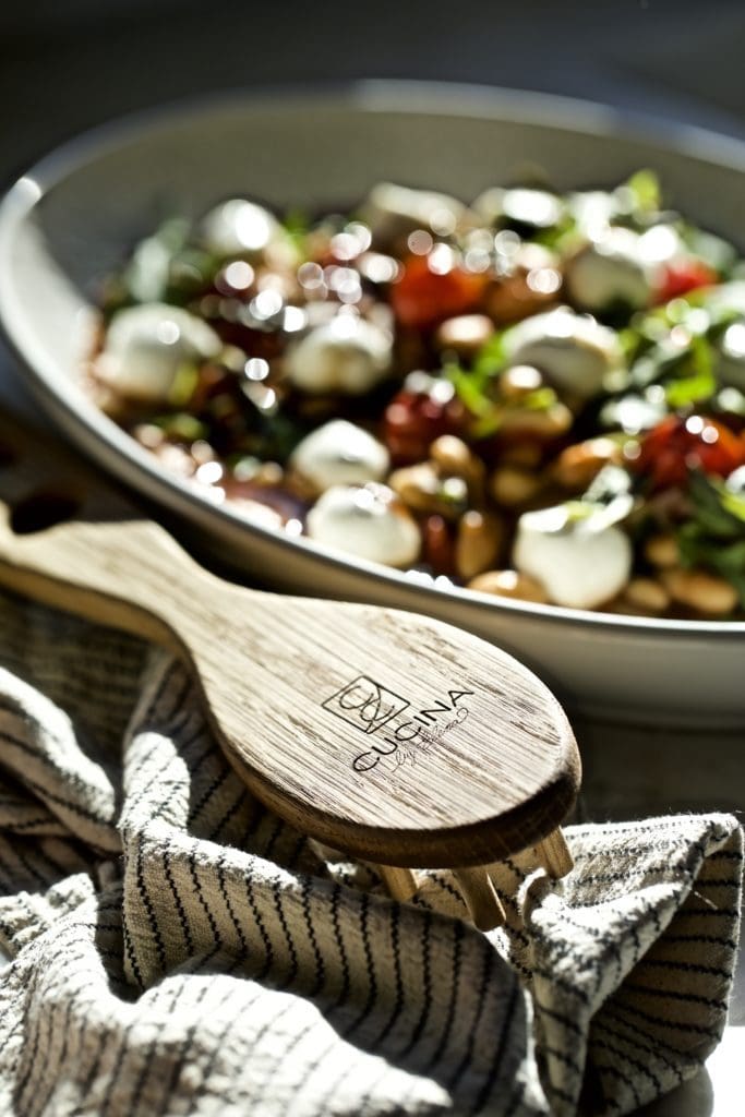 Cucina by Elena pasta server next to a bowl of warm white bean salad.