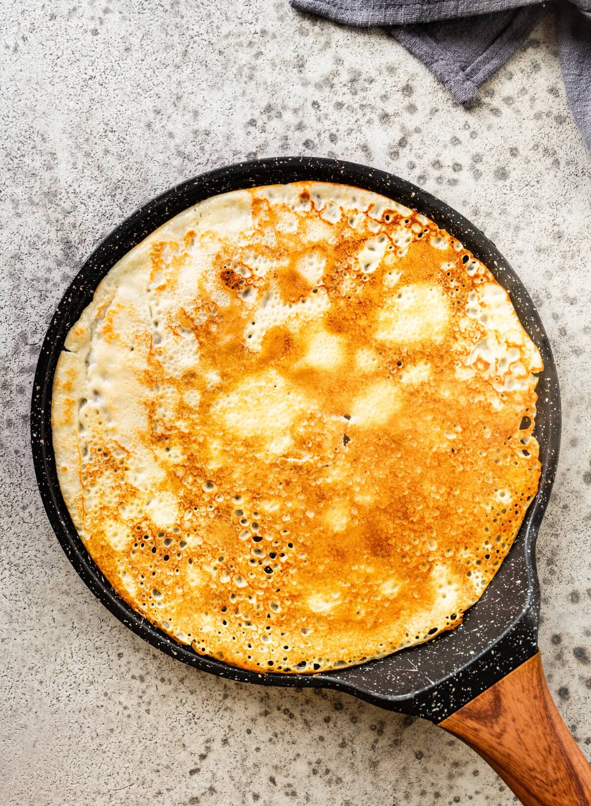 a swedish pancake on a pan after cooking.