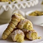 Italian cannoncini leaning on a plate.