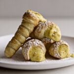 Italian cream horns on a plate with pistachio cream